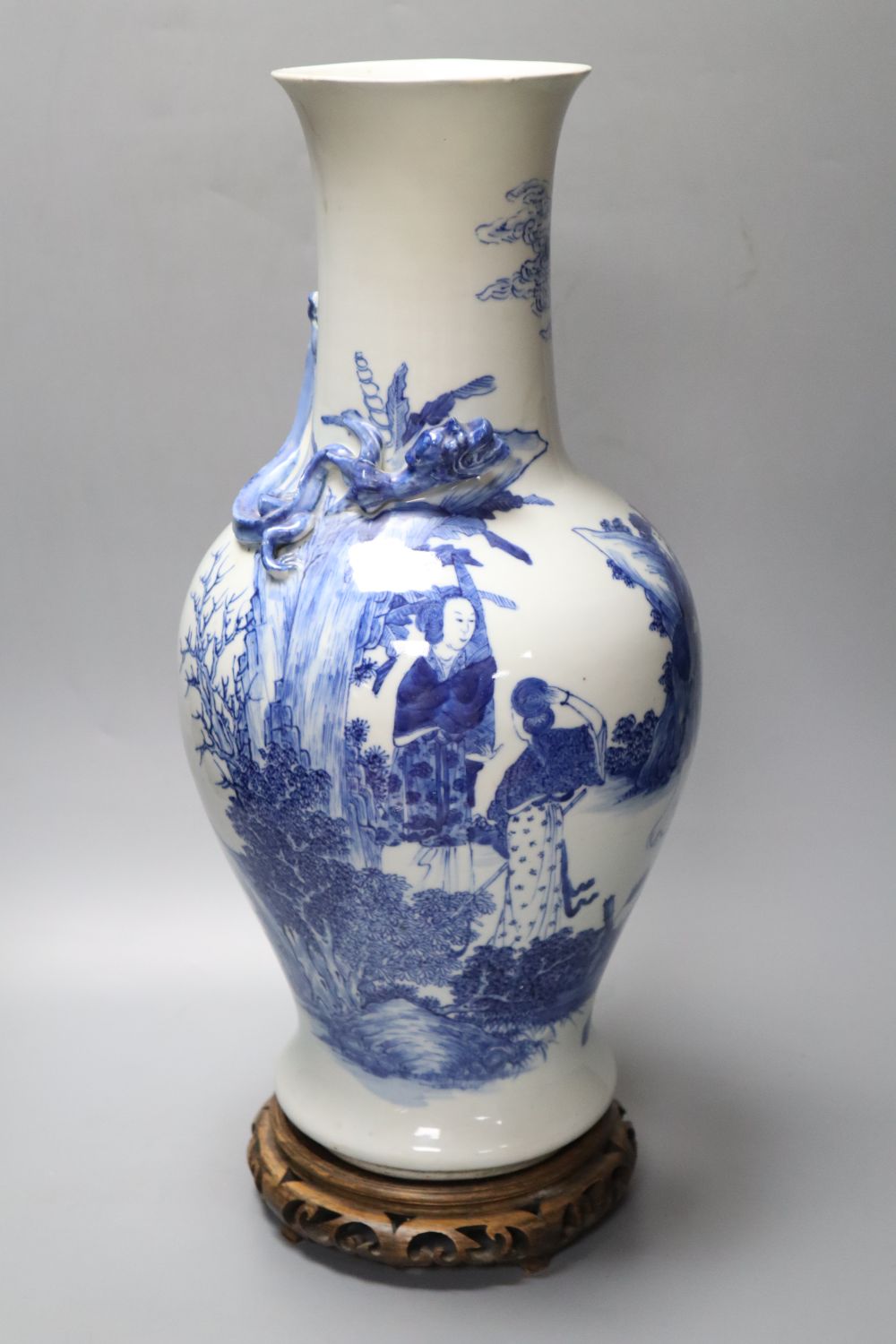 A 19th century Chinese porcelain blue and white vase and stand, neck sprigged with a serpent, on wood plinth, 49cm total height